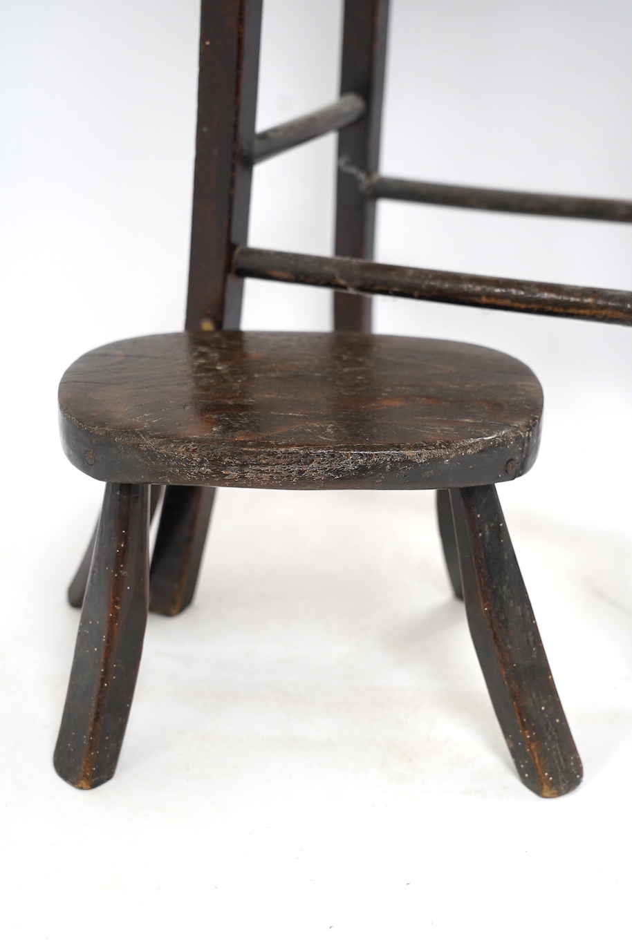 A Victorian elm and beech stool, 54cm high, together with a smaller child's stool. Condition - fair
